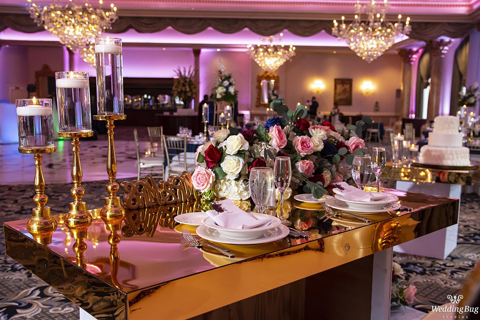 Head table gold pink and red, Pink Uplights decorate the room